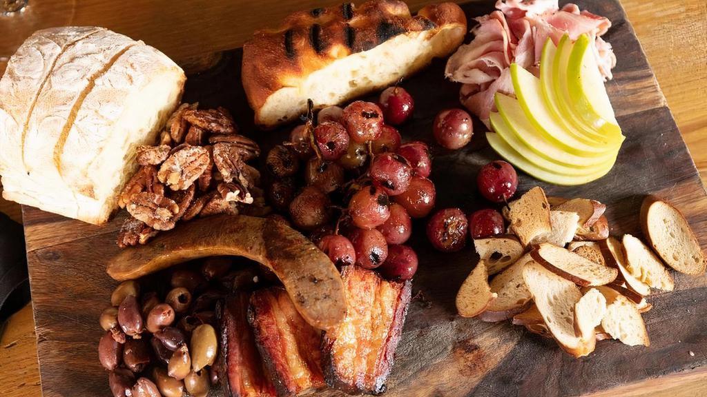 Meat Board · bacon confit, house-cured ham, fennel sausage. served with an assortment of house-baked breads, crackers, grilled grapes, sliced apples, nuts & olives