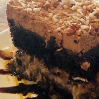 German Chocolate Cake · Sour cream chocolate cake, pecan coconut filling, chocolate frosting, whip cream, toasted co...