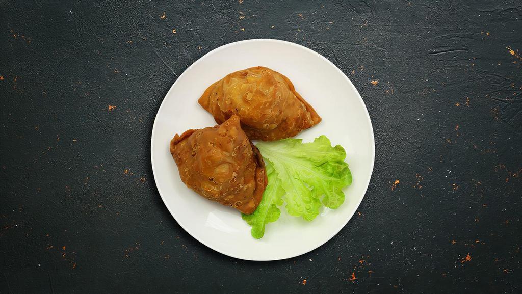 The Love Triangle (Samosa) · Triangle shaped deep fried pastry dumplings filled with spiced potatoes and vegetables