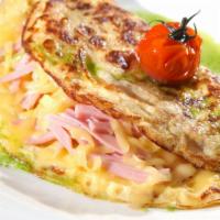 Cheese Omelette · Three eggs and melted cheese folded into a fluffy omelette. Served with homemade hash browns...