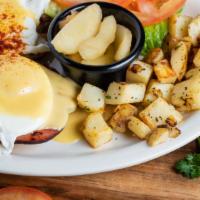Eggs Benedict · The Le peep way! Poached eggs stacked on a ham steak on top of an English muffin smothered i...
