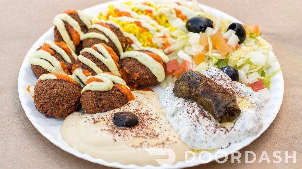 Falafel · Vegan falafel, tomatoes, lettuce, onions, tzatziki , (dairy free) garlic sauce and hot sauce. Vegan garlic sauce available.