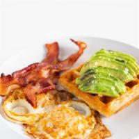Breakfast Plate · Two eggs, two slices of bacon, sliced avocado and a croissant waffle.