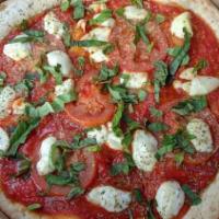 Margherita Pizza · Tomato sauce, fresh roma tomatoes, fresh basil, and fresh mozzarella.