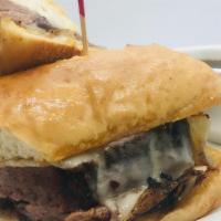 Beef Brisket Dip · smoked beef brisket, grilled onions and Swiss Cheese, served on a French Roll with a side of...