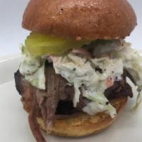 Brisket Slider · smoked beef brisket topped with creamy coleslaw and pickle, served on a brioche bun
