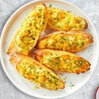 Toss The Garlic Cheese Bread · Housemade bread toasted and garnished with butter, garlic, mozzarella cheese, and parsley.