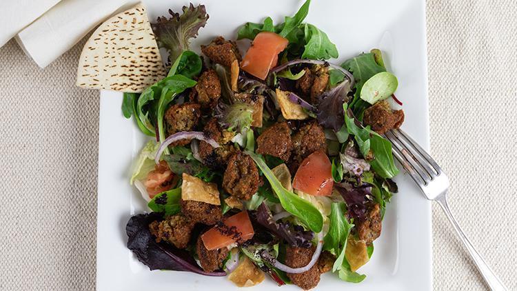 Falafel Salad · Lettuce, tomato, baby arugula, spinach,onions, pita crackers and falafel balls topped with tihini sauce and black olives.