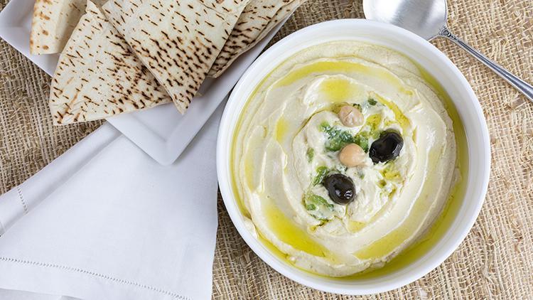 Hummus · Garbanzo beans, fresh garlic, tahini blended together and topped with extra virgin olive oil served with pita.