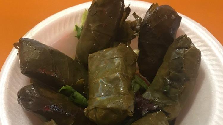 Dolma · stuffed grape leaves with rice and seasoned vegetables, cooked with lemon and extra virgin olive oil.