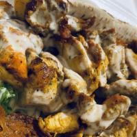 Chicken Shawarma · Marinated and flame broiled chicken with tomatoes, lettuce, cucumber pickles, garlic spread ...