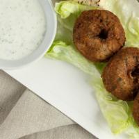 Falafel · Freshly made falafel balls with lettuce, tomatoes, cucumber pickles and tahini wrapped in a ...