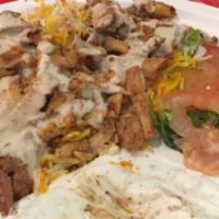 Chicken Shawarma · Marinated slices of chicken out of the spinning spit comes on either saffron basmati rice or...