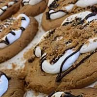 S'More Love · Graham cracker cookie topped with marshmallows and a chocolate drizzle.