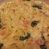Padrino’S Fettuccini · Fettuccini pasta in creamy alfredo sauce with chicken, spinach, and chopped tomatoes.