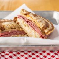Reuben · CORNED BEEF COOKED OVER SAUERKRAUT WITH SWISS CHEESE, TOPPED WITH HOUSE-MADE RUSSIAN DRESSIN...