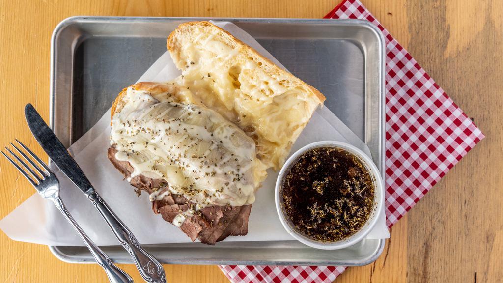 French Dip · THINLY SLICED ROAST BEEF TOPPED WITH PROVOLONE CHEESE AND HORSERADISH MAYONNAISE, SERVED WITH A CUP OF HOUSE-MADE AU JUS