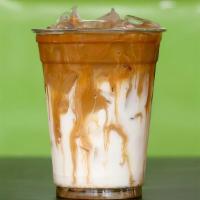 Caramel Latte · Real caramel sauce, dillanos coffee and milk.  *pictured layered, but comes stirred.