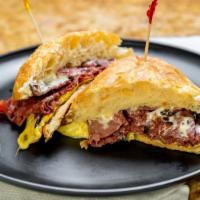 The Pastrami · Warm pastrami, fluffy eggs, Swiss cheese, and our special white sauce on a lightly toasted c...