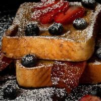 The French Toast · Strawberries and blueberries over cinnamon Texas French toast dusted with powdered sugar and...