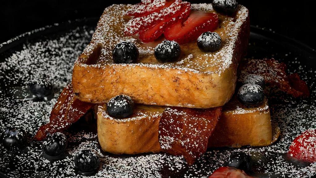 The French Toast · Strawberries and blueberries over cinnamon Texas French toast dusted with powdered sugar and topped with bacon. Comes with our homemade warm caramel syrup. 

* No substitutions, just eliminations.