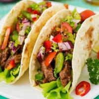 Tacos  X 4 · Corn tortilla, Your choice of meat, cilantro onions and salsa. The pastor tacos include litt...