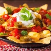 Nachos · Tortilla chips covered with melted cheese, pico de gallo, black beans and meat.