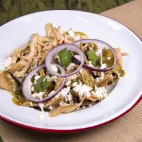 Chilaquiles · Tortilla chips smothered in salsa, topped with onions and mozzarella, served with 2 eggs, si...