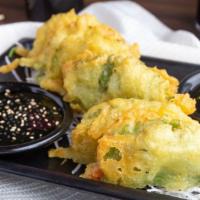 Dragon Scales · Spicy tuna delicately pressed between two Japanese shiso leaves then lightly tempura fried, ...
