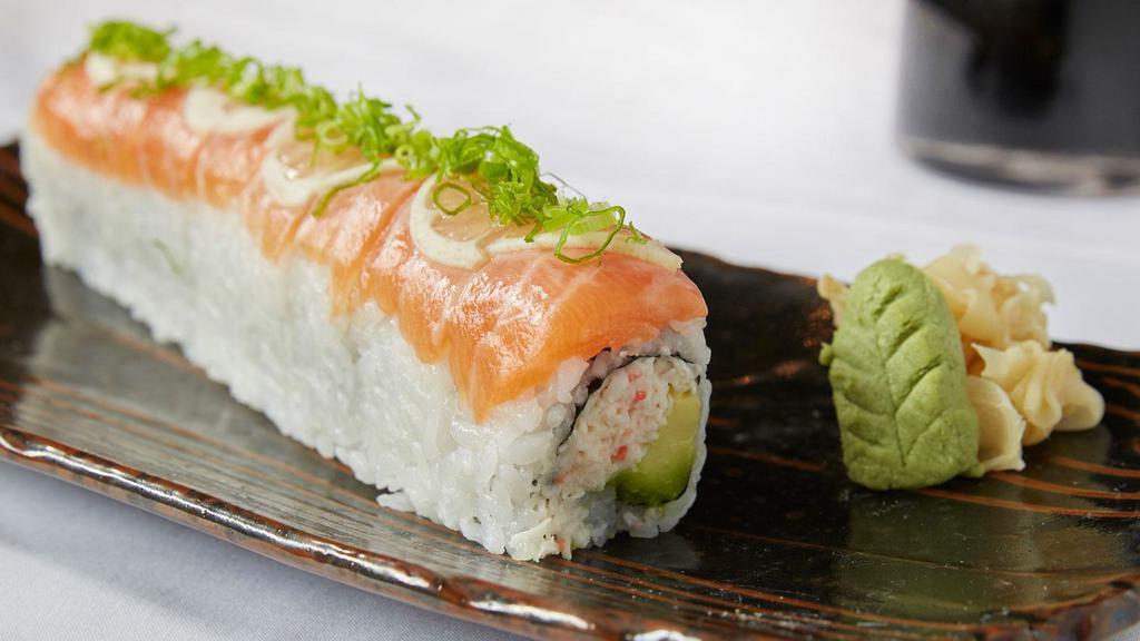 Sunset Roll · Crab and avocado topped with salmon sashimi, lemon, ponzu sauce and green onion.