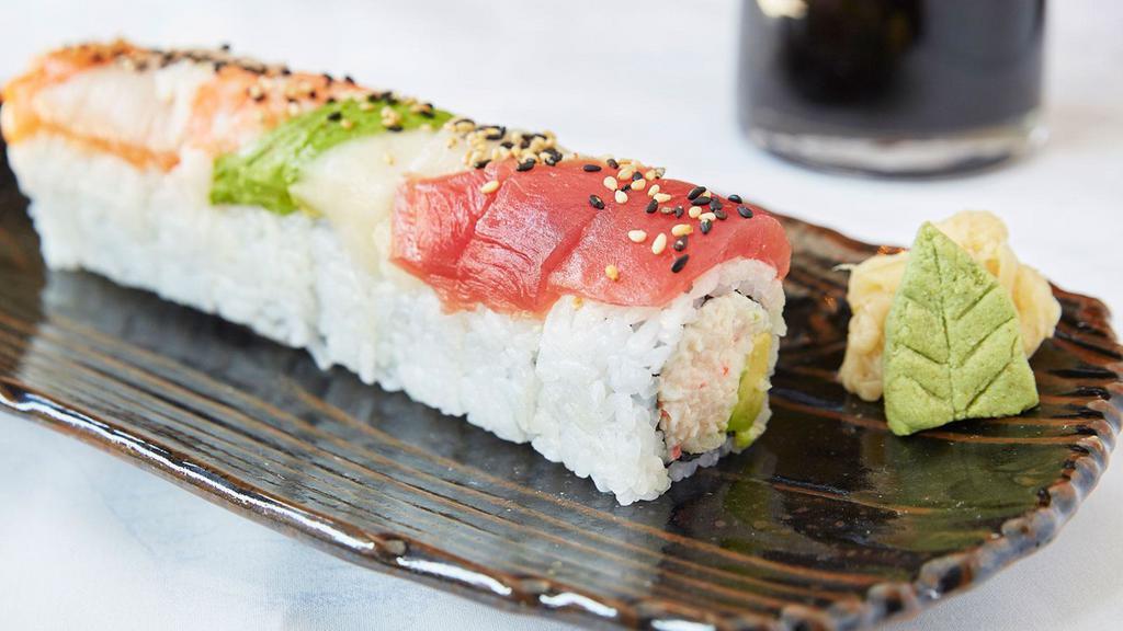 Rainbow Roll · Crab and avocado rolled inside out, topped with five types of sashimi and sesame seeds.