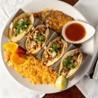 Street Style Tacos · 4 street tacos with two choices of meat, served with corn tortillas, Spanish rice, and refri...