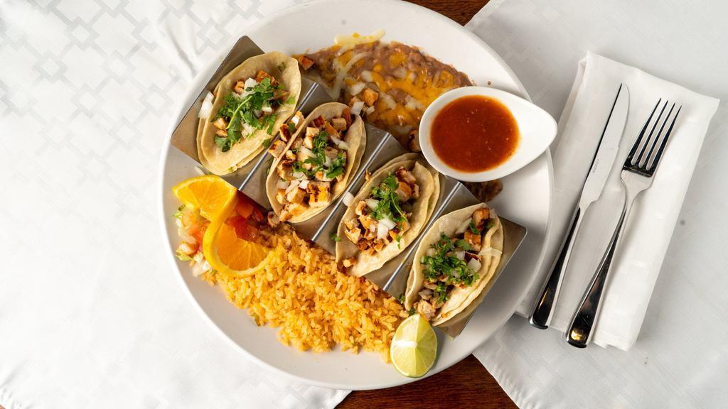 Street Style Tacos · 4 street tacos with two choices of meat, served with corn tortillas, Spanish rice, and refried beans. (substitutions... black beans, whole beans, white rice, flour tortillas, and lettuce wraps available).