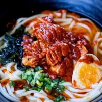 Spicy Udon · Thick Japanese udon noodles, spicy. chicken, seaweed, scallions & soft boiled half egg in so...