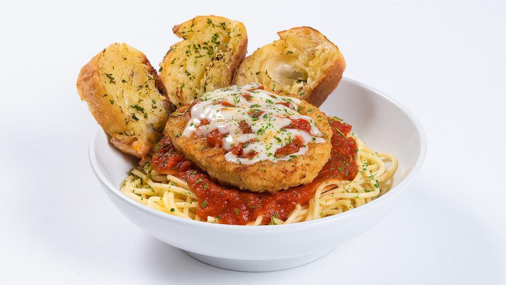 Chicken Parmesan · Spiced and breaded chicken parmesan on top of traditional Italian pasta. Baked with marinara and melted mozzarella and served with warm garlic bread.