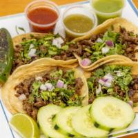 Tacos · Acompañados con mixto de repollo, cilantro y cebolla morada. Pepinos, salsa de guacamole, sa...
