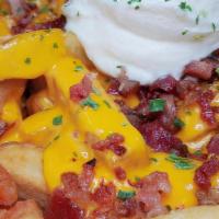 King Fries (Regular) · Fresh cut fries loaded with cheese sauce, chopped bacon, sour cream and chives.