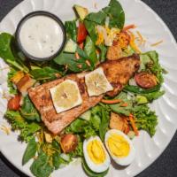 Blackened Salmon Salad · Cooked salmon salad with spinach, lettuce tomatoes, cucumbers, croutons, onion, carrots and ...
