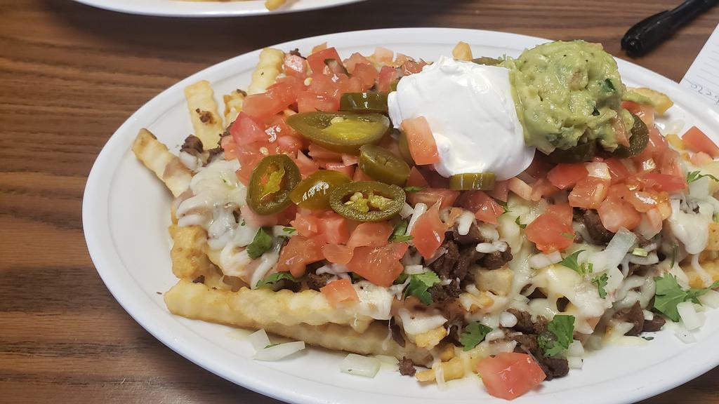 Asada Fries · French fries with cheese, onions, your choice of meat, cilantro, onions, jalapeños, sour cream, & guacamole