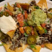 Nachos · Freshly made chips with your choice of meat, cheese, jalapeños, sour cream, guacamole, onion...