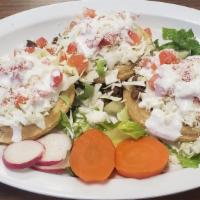Sopes (3) · 3 thick tortillas laid on lettuce. Includes refried beans, your choice of meat, onions, cila...