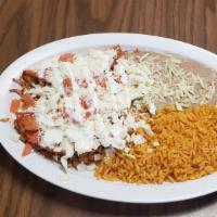 Enchiladas Rancheras · 2 fried tortillas with your choice of meat with sour cream, cabbage, cheese, & tomatoes. inc...