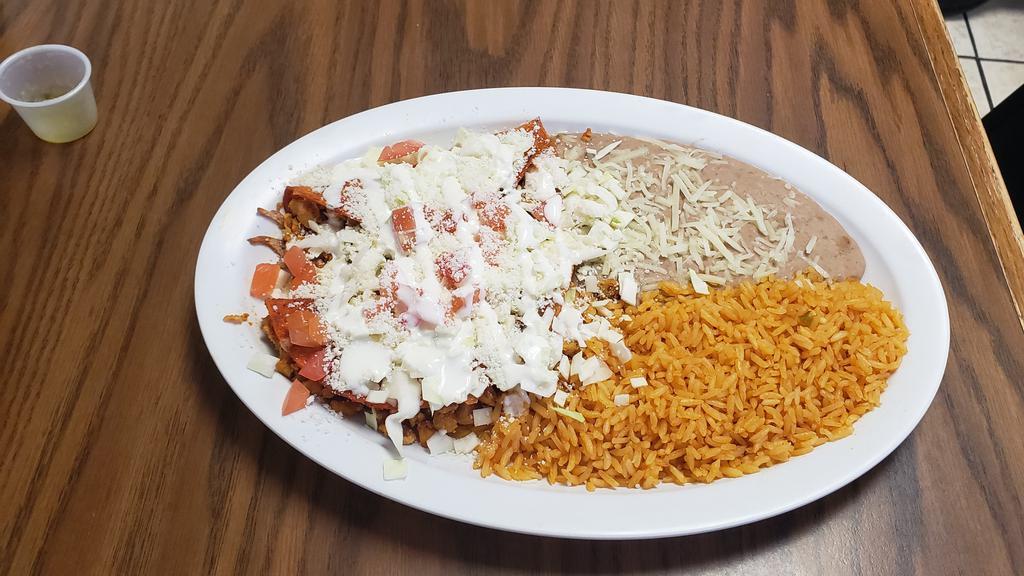 Enchiladas Rancheras · 2 fried tortillas with your choice of meat with sour cream, cabbage, cheese, & tomatoes. includes rice and beans.