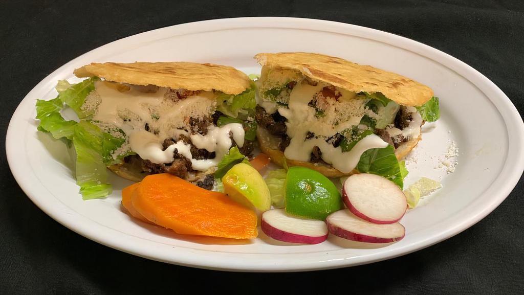 Gorditas (2) · 2 thick tortillas filled with refried beans, your choice of meat, onions, cilantro, salsa, lettuce, tomatoes, Mexican cheese, & sour cream