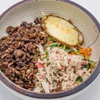 Bi Bim Bap · Fresh vegetables over rice, served with chopped steak and a fried egg. Mix with spicy red sa...