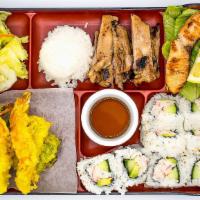 Bento B · A colorful assortment of rice, salad, chicken teriyaki, salmon teriyaki, tempura and eight p...