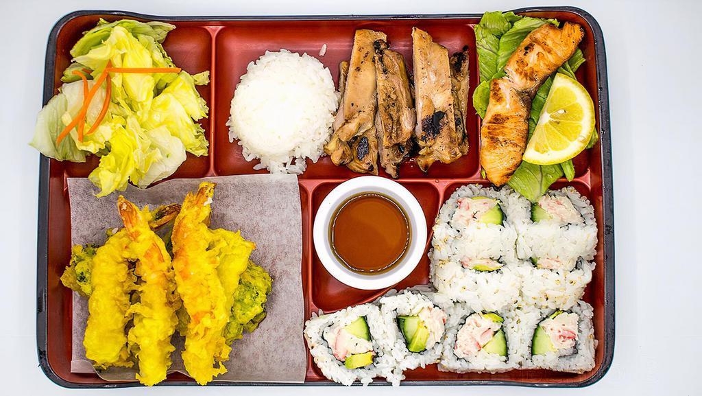 Bento B · A colorful assortment of rice, salad, chicken teriyaki, salmon teriyaki, tempura and eight pieces of California rolls.