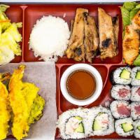 Bento A · A colorful assortment of rice, salad, chicken teriyaki, salmon teriyaki, tempura and six pie...