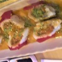 Love · Raw fish, spicy level one. In: spicy tuna, avocado wrapped in tuna sashimi, green onion. Sau...