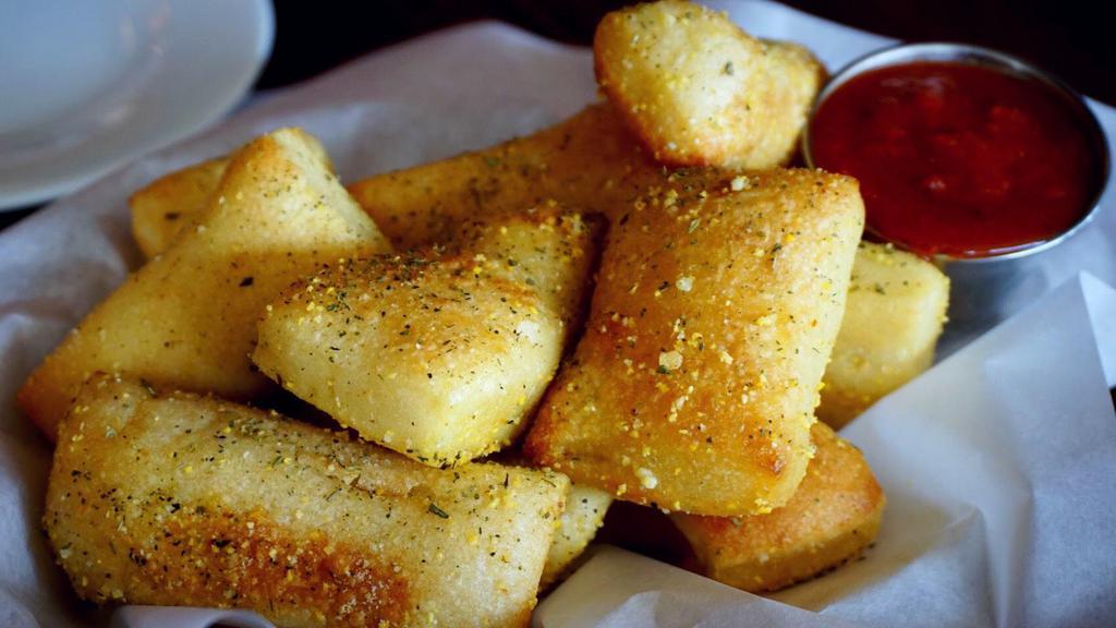 Passion Bread · Tasty bread tossed with garlic butter, parmesan cheese and Italian spices. Served with a side of marinara sauce.